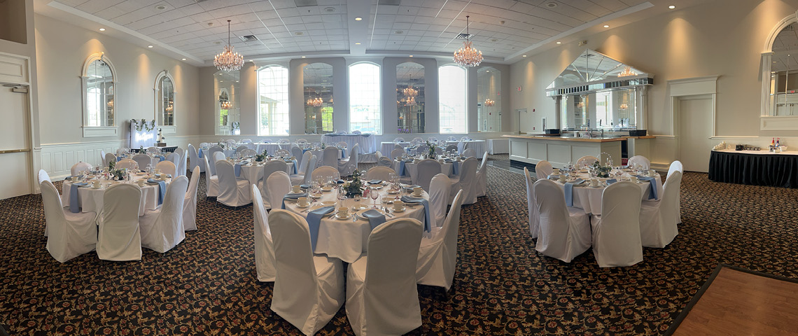 White and blue linens on tables in a banquet hall