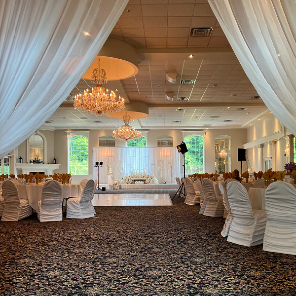 White linens framing a decorated banquet hall