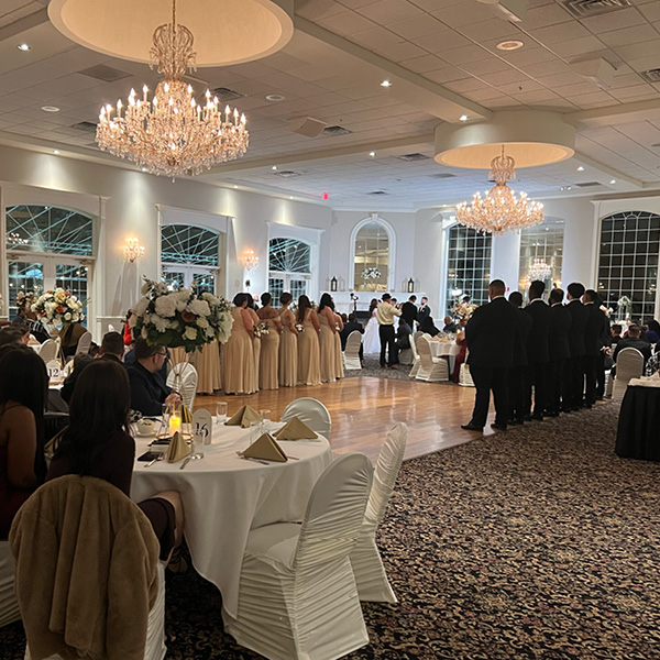 Wedding party lining a dance floor