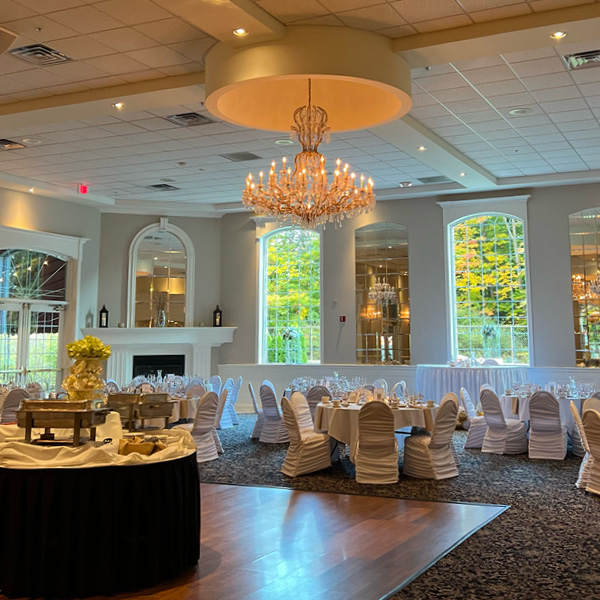 Banquet hall with large windows, fall foliage and chandeliers