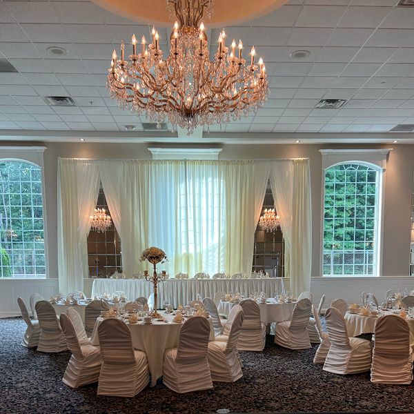 Grand banquet hall with huge windows and a large chandelier