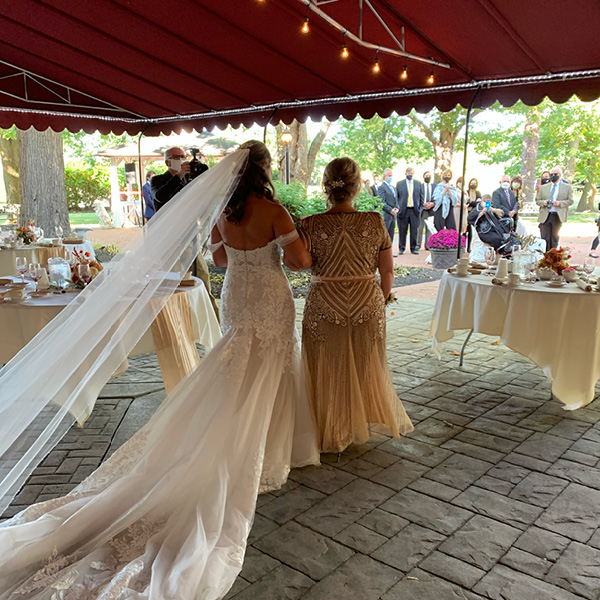 Bride with her mother under the patio